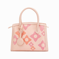 A pink crossbody bag with a geometric pattern and a zipper closure.